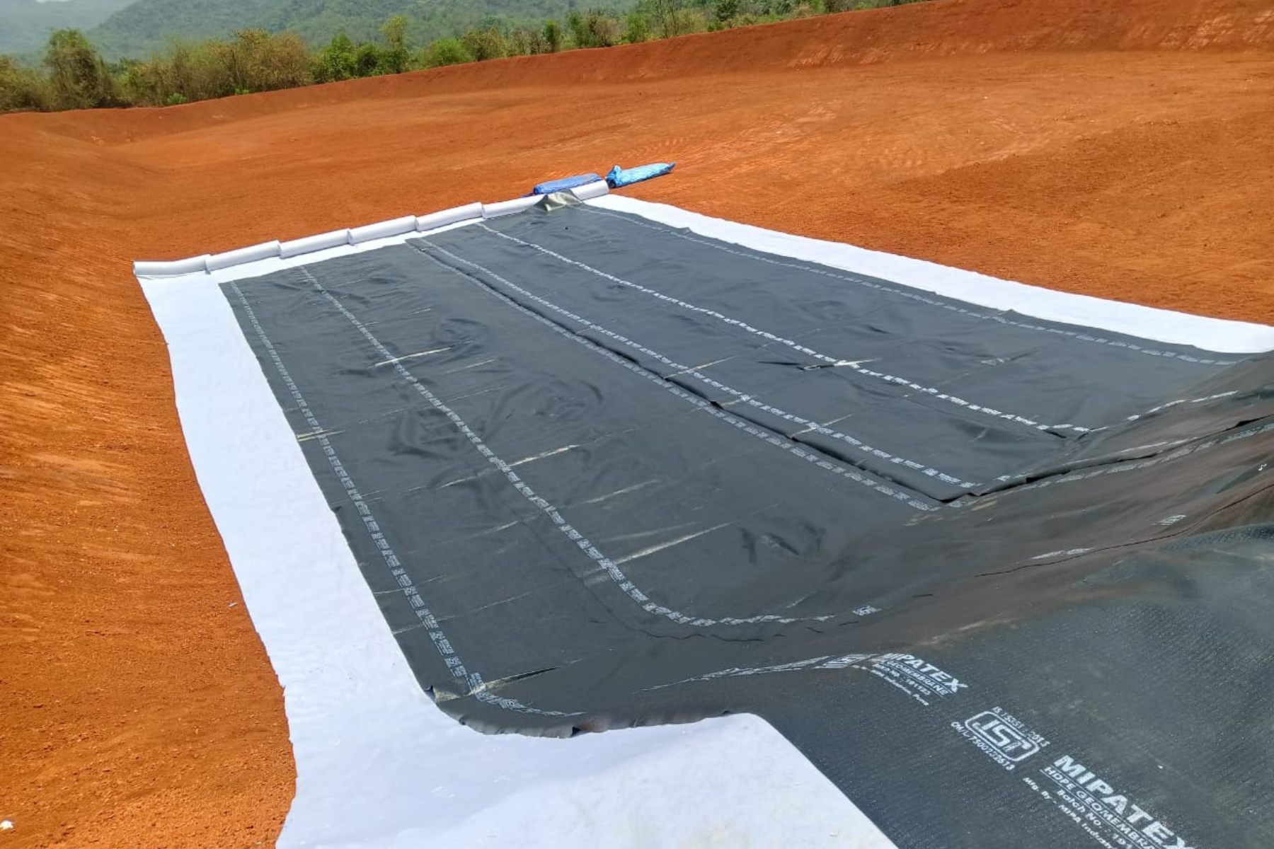 MIPATEX HDPE geomembrane liner installation for farm pond and irrigation water storage.