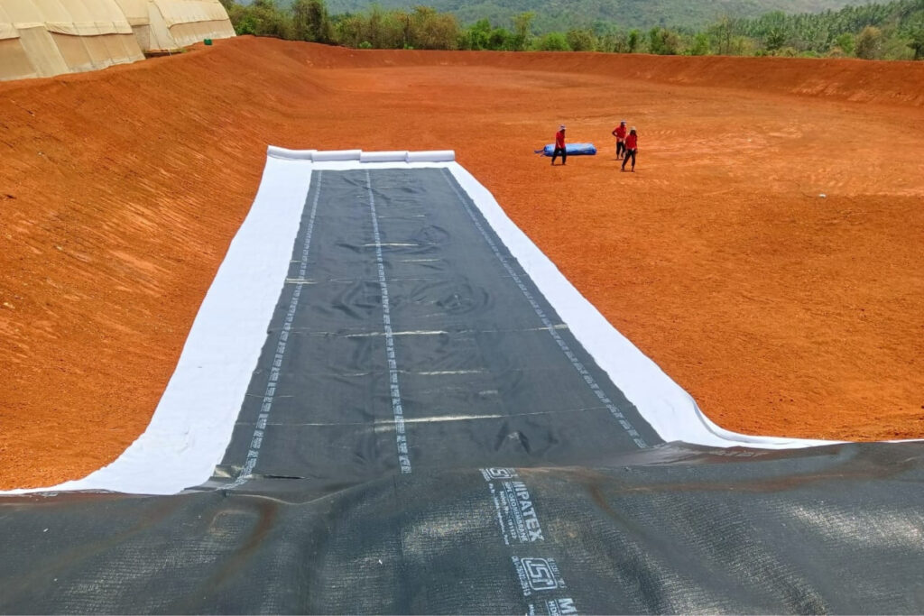 Installation of MIPATEX HDPE geomembrane liner with geotextile protection for farm pond waterproofing.