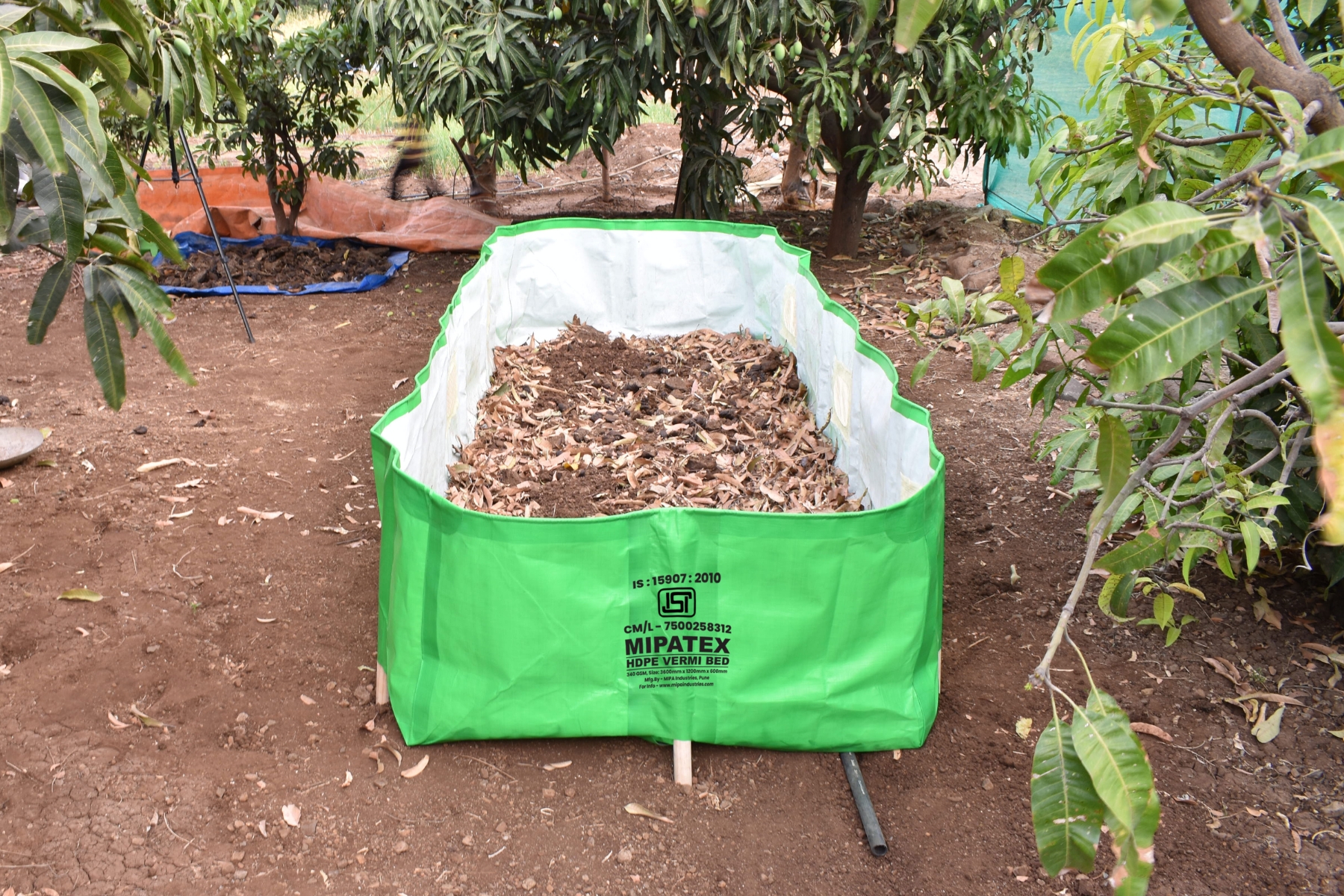 MIPATEX HDPE Vermicompost Bed in use for organic composting under trees.